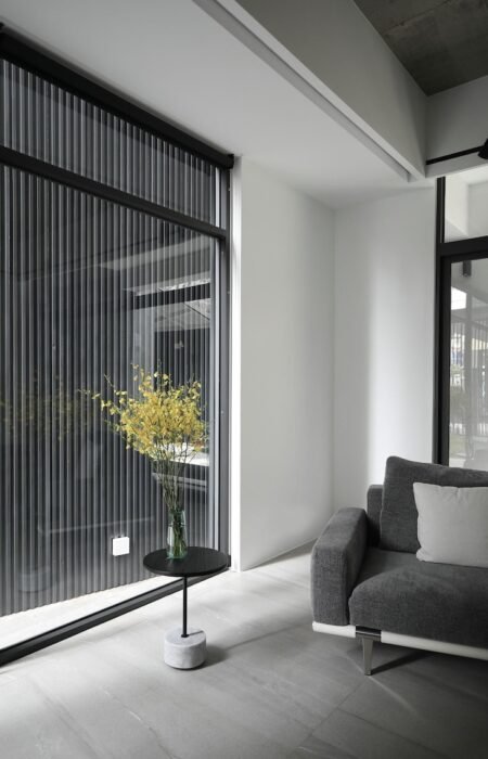 room-with-large-window-that-has-vase-flowers-it_1310085-3178